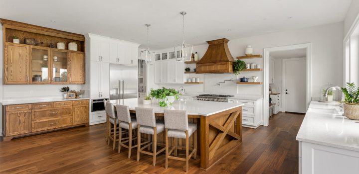 Spacious living area with a blend of classic and modern design elements, featuring a kitchen with state-of-the-art appliances and a cozy dining set.