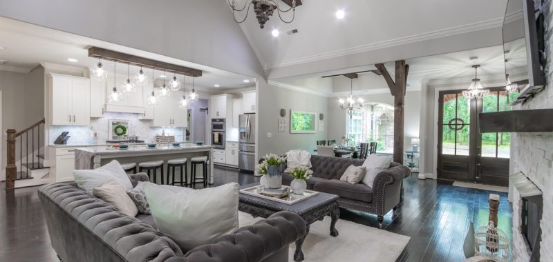 Stylish living room decorated in neutral tones, showcasing a modern fireplace, plush furnishings, and decorative lighting that adds a touch of elegance.